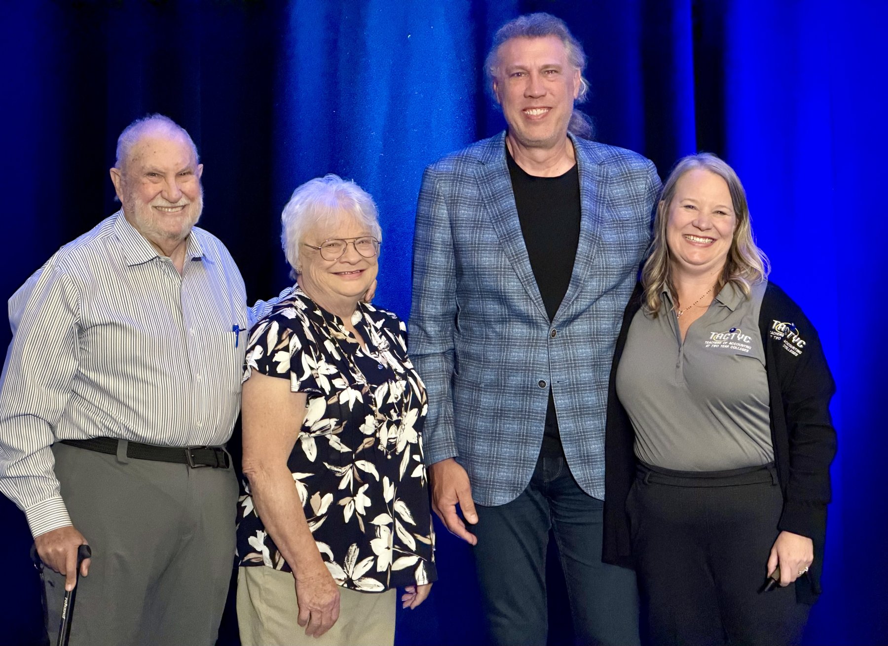 The Miller family together at the TACTYC annual conference, in front of a blue stage curtain